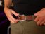 Dark brown leather belt with stitching and silver buckle