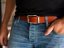 Brown leather belt with stitching and silver buckle